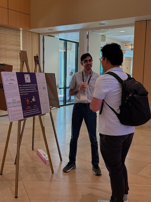 Me presenting the poster for "Aligning Language Models with Observational Data: Opportunities and Risks from a Causal Perspective" at EC'25